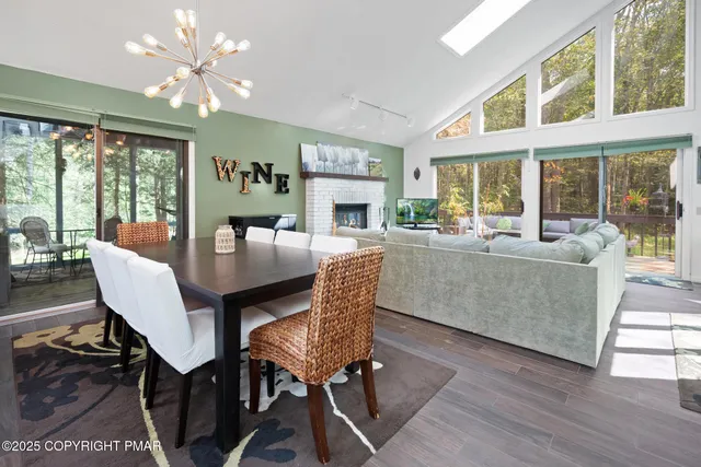 a view of a dining room with furniture wooden floor and chandelier