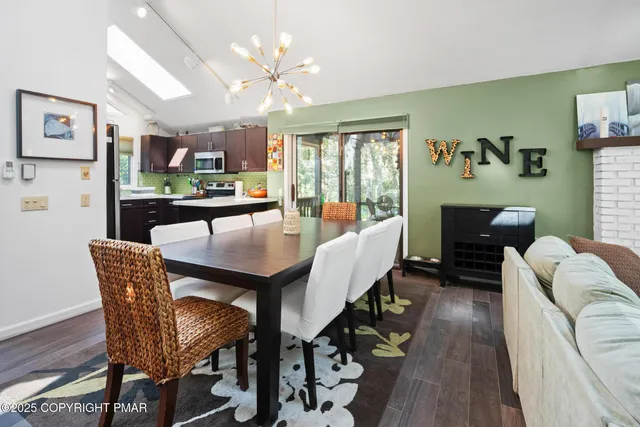 a dining room with furniture a rug and wooden floor