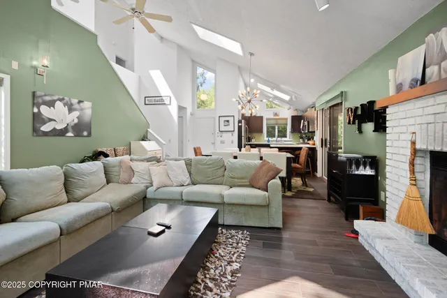 a living room with furniture wooden floor and a fireplace