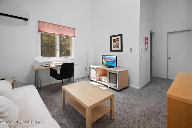 a living room with furniture a window and a table