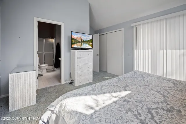 a bedroom with a bed and a view of bathroom