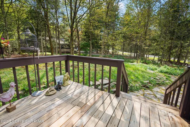 a view of balcony with wooden floor and fence
