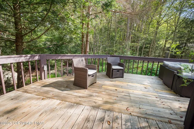 a view of roof deck with wooden floor and fence
