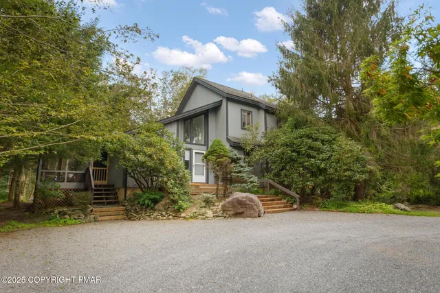 a yellow house with trees in front of it