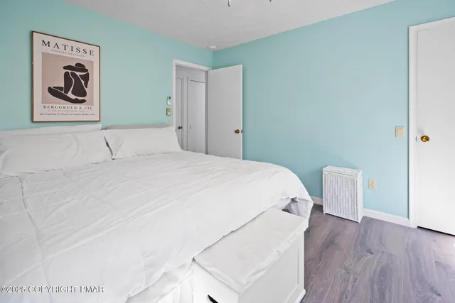 a bedroom with a bed and a wall painting