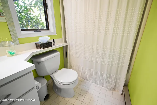 a white toilet sitting next to a sink