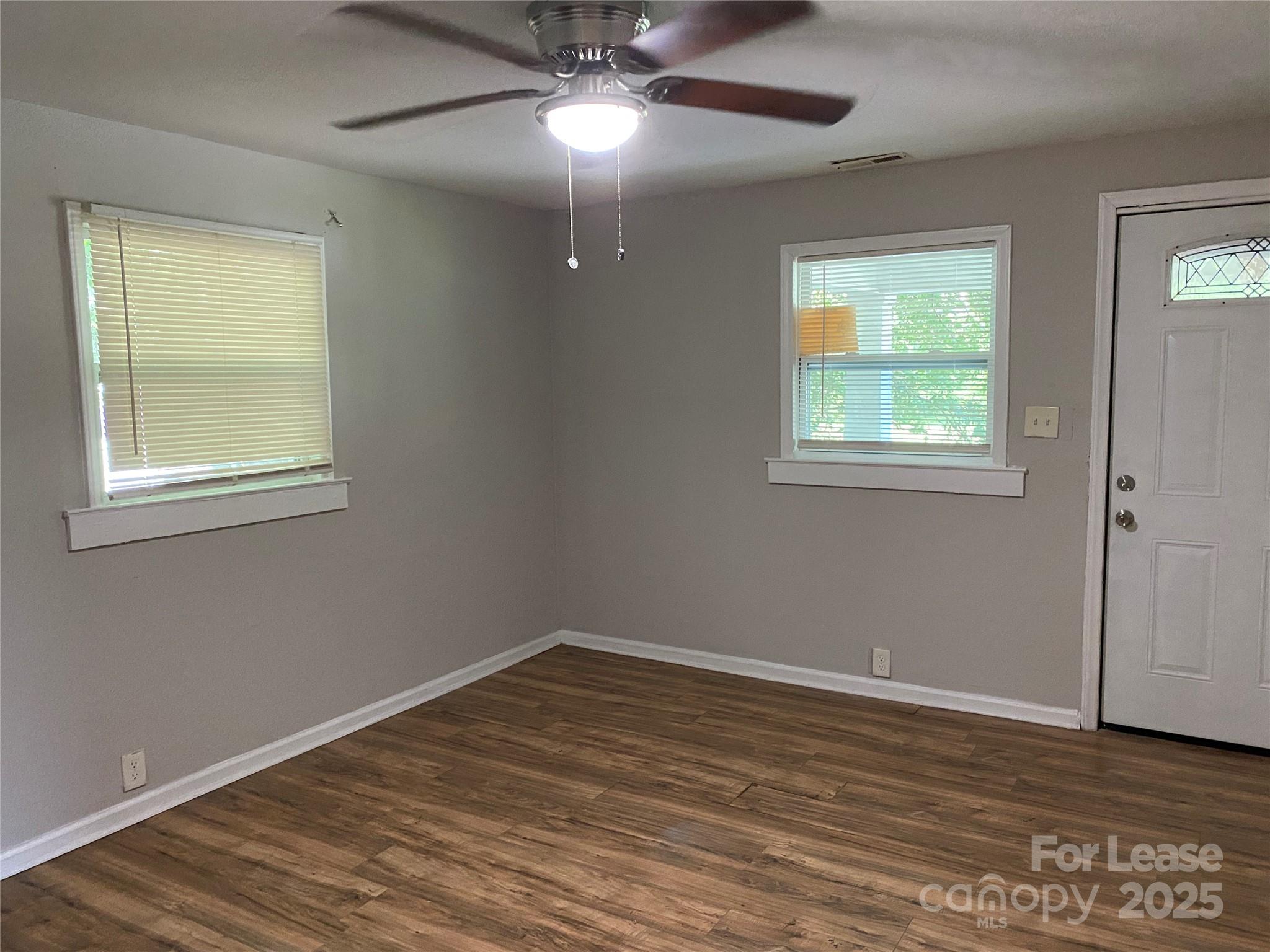 324 North Pryor Street Gastonia, NC 28052 - Photo 2 of 9 a view of an empty room with wooden floor and a window