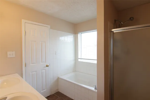 a bathroom with a bathtub and shower