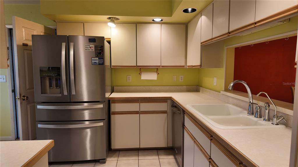 1767 Southeast 27th Loop Ocala, FL 34471 - Photo 15 of 79 a kitchen with a refrigerator sink and cabinets