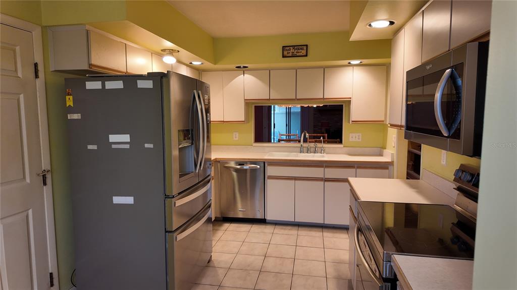 1767 Southeast 27th Loop Ocala, FL 34471 - Photo 16 of 79 a kitchen with stainless steel appliances a refrigerator sink and microwave
