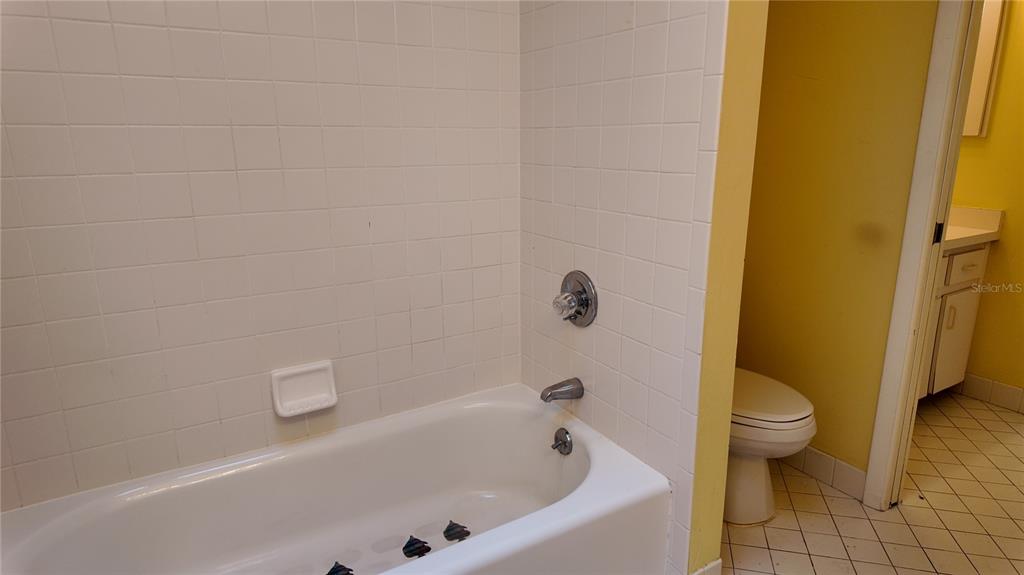1767 Southeast 27th Loop Ocala, FL 34471 - Photo 57 of 79 a bathroom with a bathtub and a toilet