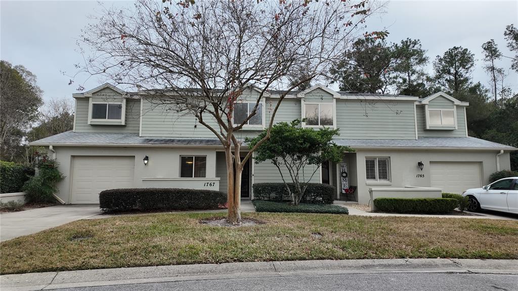 1767 Southeast 27th Loop Ocala, FL 34471 - Photo 10 of 79 a front view of a house with a yard and garage
