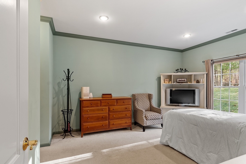 33 Summerfield Drive, Unit 33 Uxbridge, MA 01569 - Photo 18 of 21 a bed room with a bed and a fireplace