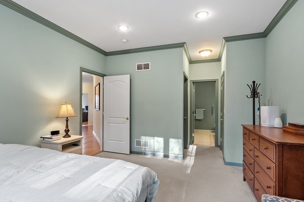 33 Summerfield Drive, Unit 33 Uxbridge, MA 01569 - Photo 19 of 21 a bedroom with a bed and a dresser