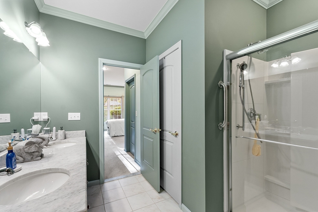 33 Summerfield Drive, Unit 33 Uxbridge, MA 01569 - Photo 20 of 21 a bathroom with a tub shower and sink