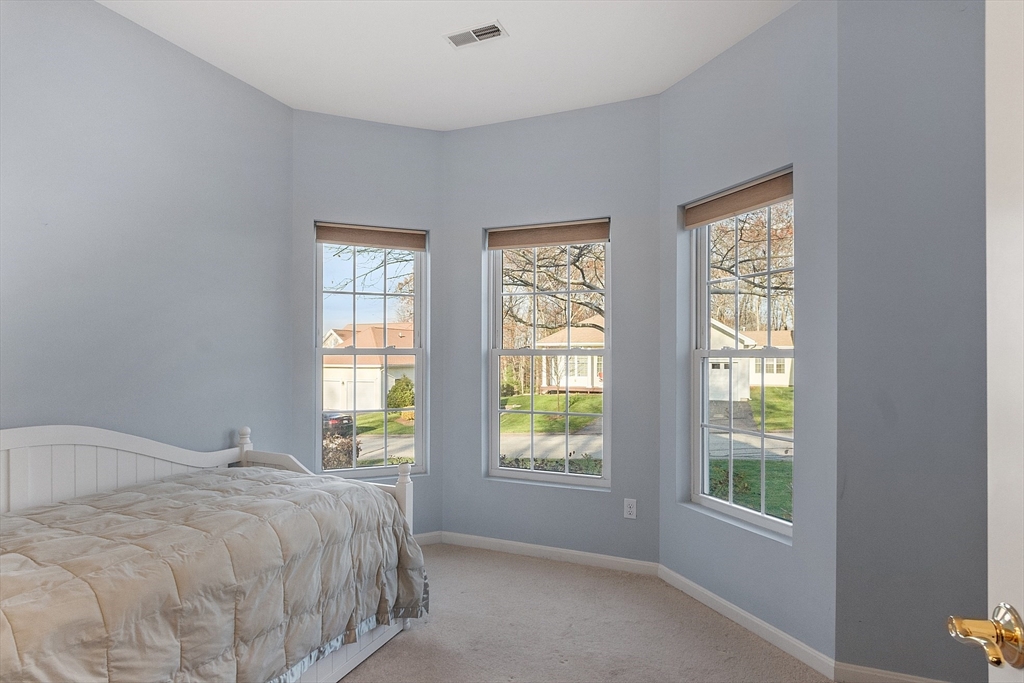 33 Summerfield Drive, Unit 33 Uxbridge, MA 01569 - Photo 6 of 21 a bed sitting in a bedroom next to a window