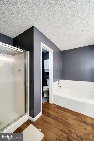 a bathroom with a bathtub and a shower