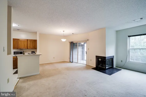 a living room with furniture a flat screen tv and a window
