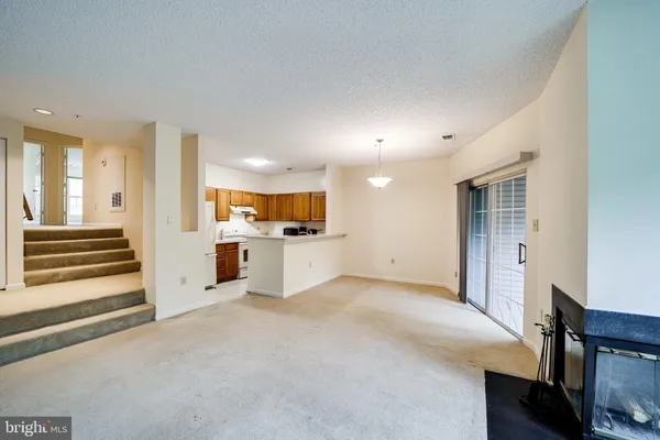 a view of a kitchen with a sink and a refrigerator