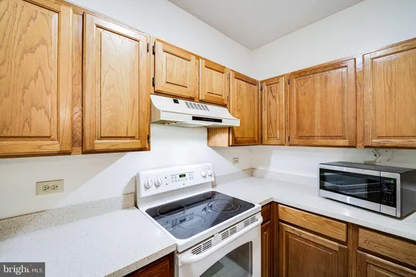 a kitchen with a stove a sink and a cabinets
