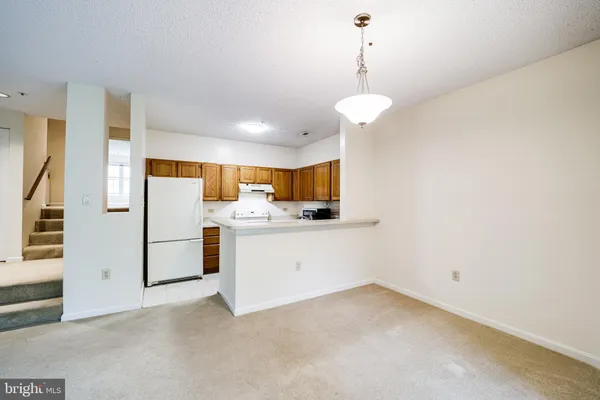a view of a kitchen with electric appliances