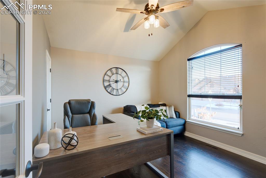 1112 Spectrum Loop Colorado Springs, CO 80921 - Photo 16 of 50 Home office featuring vaulted ceiling, ceiling fan, and dark wood-type flooring