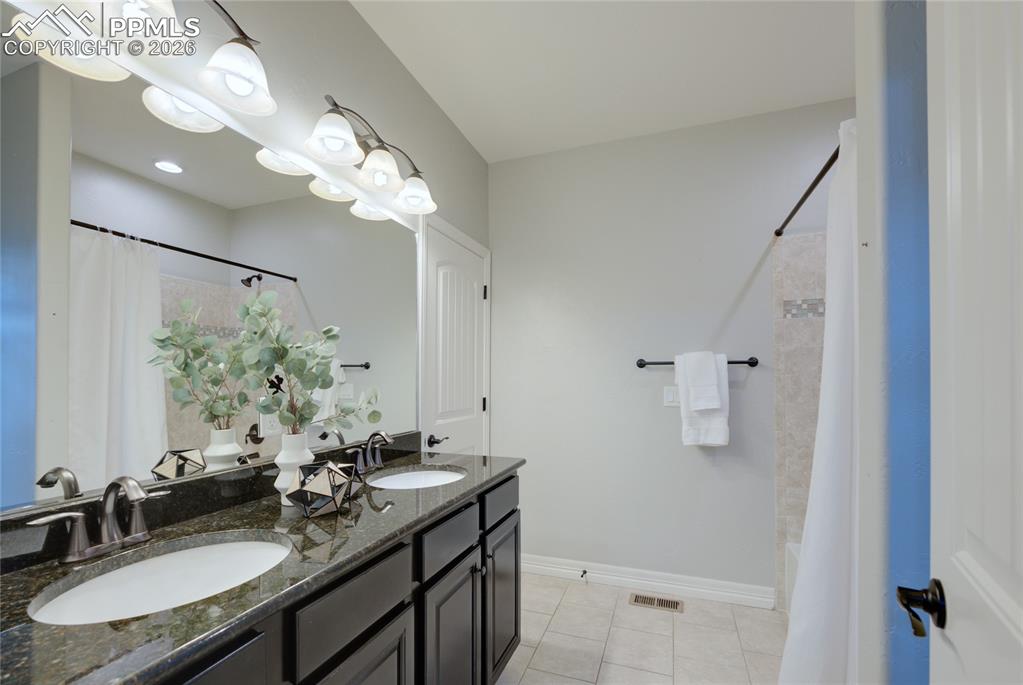 1112 Spectrum Loop Colorado Springs, CO 80921 - Photo 18 of 50 Bathroom featuring double vanity and light tile patterned floors