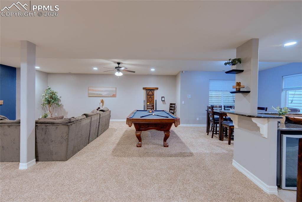 1112 Spectrum Loop Colorado Springs, CO 80921 - Photo 23 of 50 Rec room featuring wine cooler, recessed lighting, pool table, light colored carpet, and ceiling fan