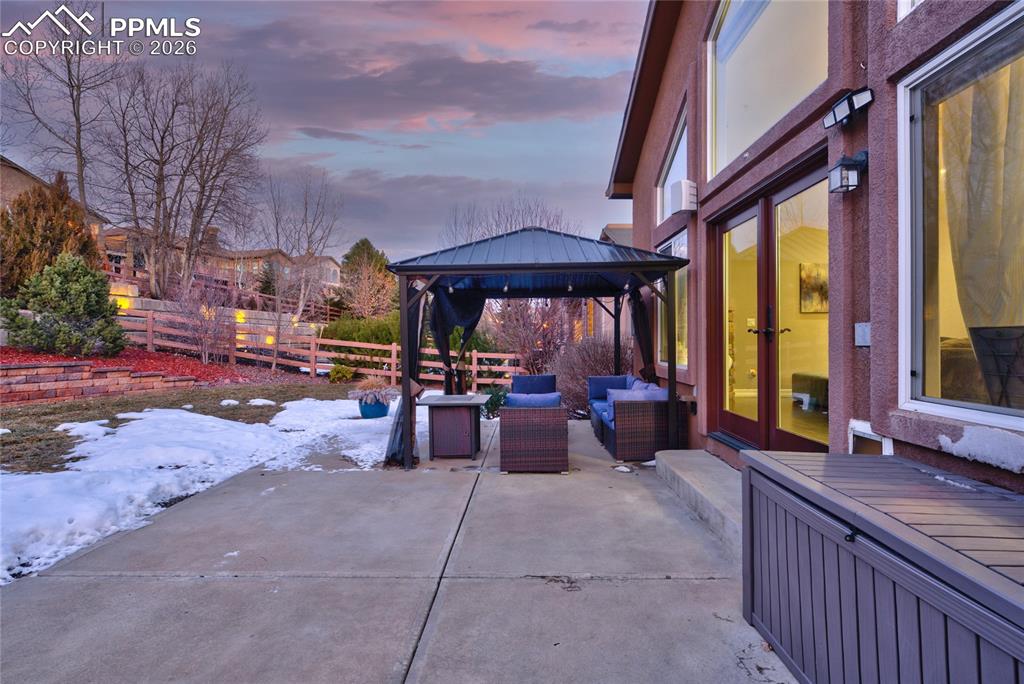 1112 Spectrum Loop Colorado Springs, CO 80921 - Photo 37 of 50 Snow covered patio with a gazebo, an outdoor living space, a patio area, and french doors