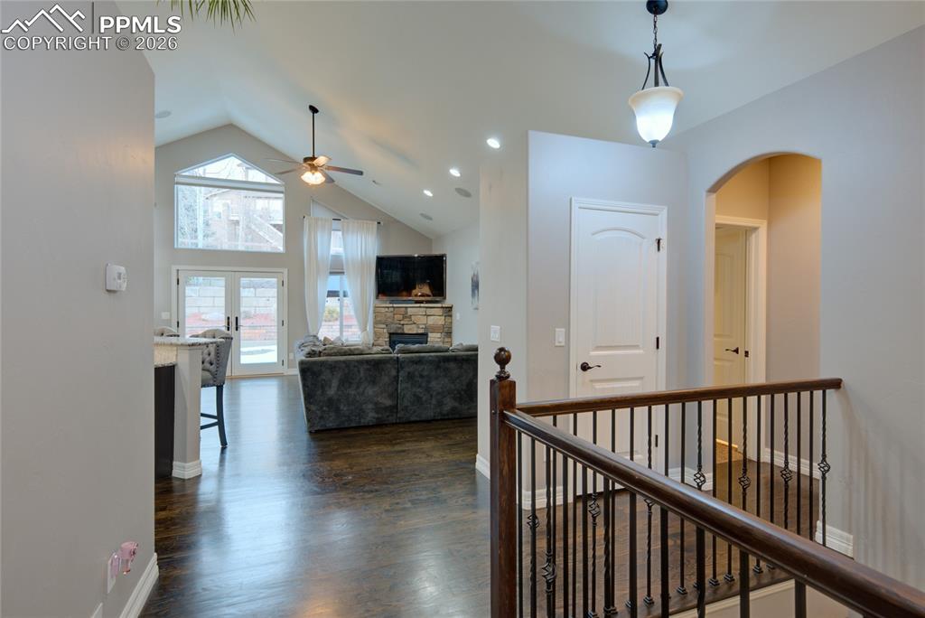 1112 Spectrum Loop Colorado Springs, CO 80921 - Photo 4 of 50 Hallway featuring dark wood-type flooring, high vaulted ceiling, french doors, and recessed lighting