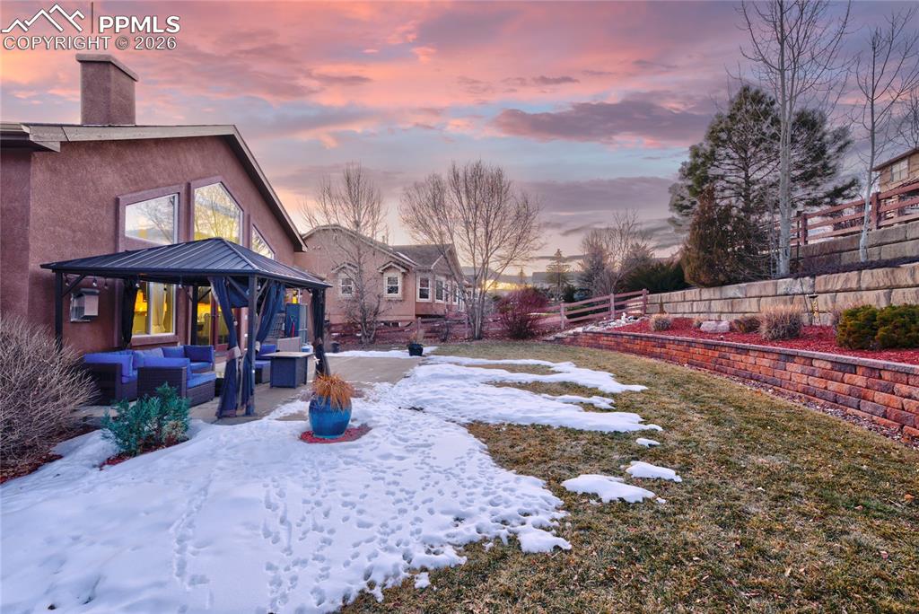 1112 Spectrum Loop Colorado Springs, CO 80921 - Photo 41 of 50 Snowy yard featuring an outdoor hangout area, a patio, and a gazebo