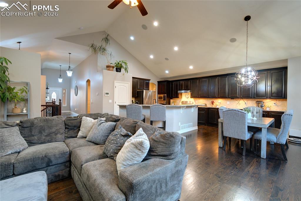 1112 Spectrum Loop Colorado Springs, CO 80921 - Photo 6 of 50 Living area with high vaulted ceiling, recessed lighting, dark wood-style floors, and ceiling fan