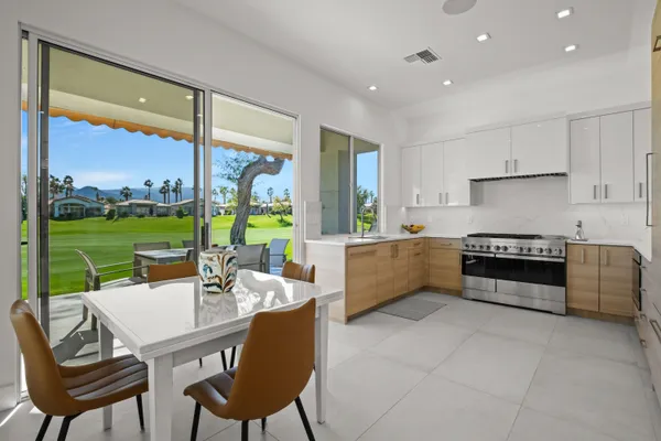a kitchen with stainless steel appliances granite countertop a stove and a sink
