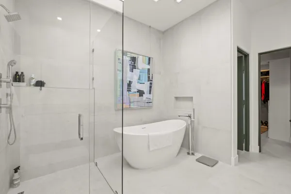 a view of walk in closet with clothes