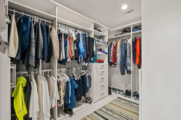 a bedroom with a large bed and a chandelier