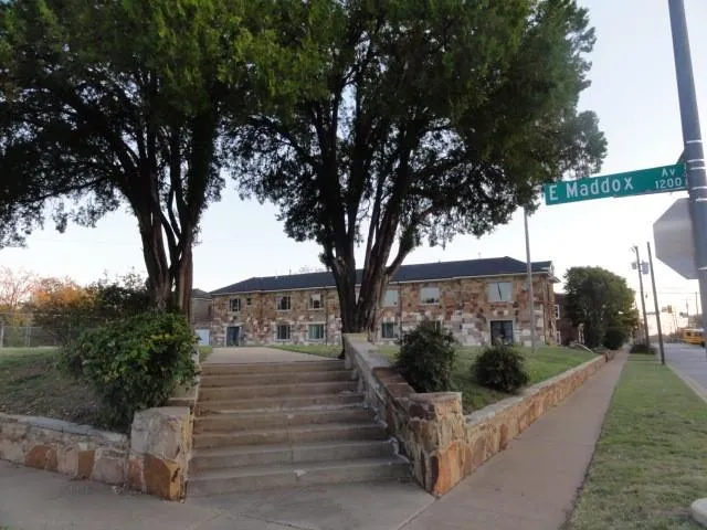 a view of a house with a tree in front