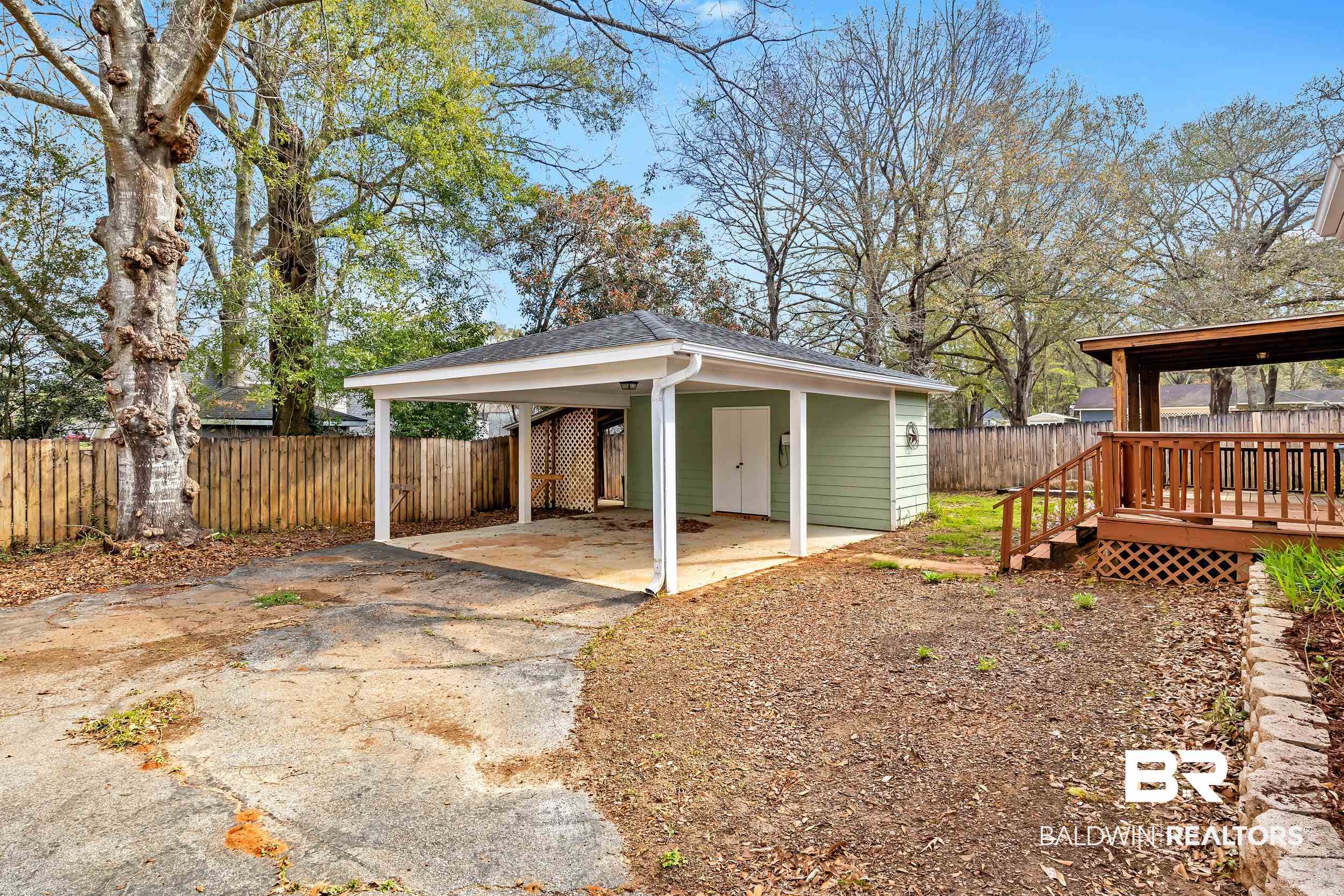 6616 Conde Court Mobile, AL 36695 - Photo 25 of 27 View of outdoor structure with concrete driveway, fence, and a carport