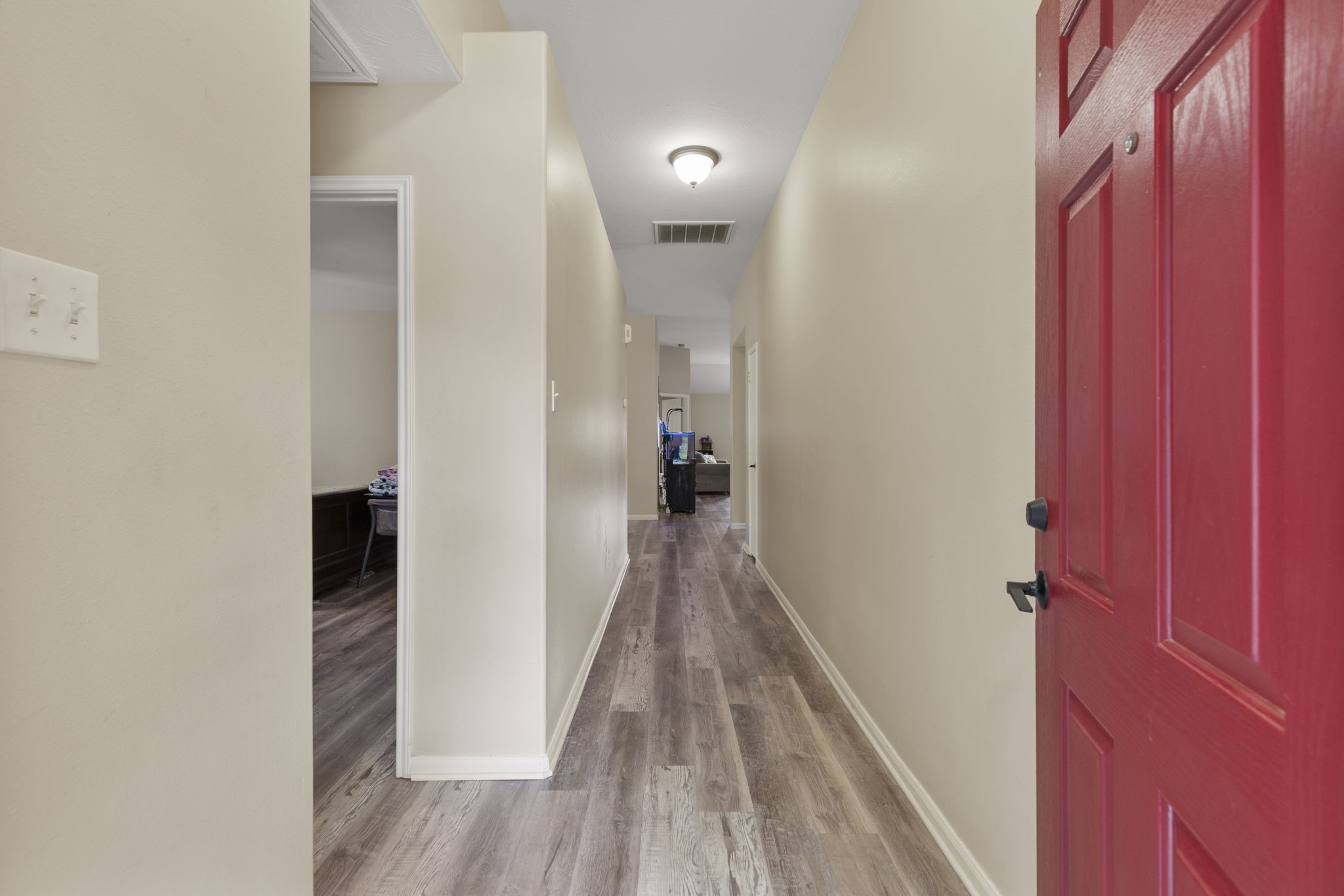 29106 Foxingham Circle Spring, TX 77386 - Photo 4 of 47 a view of a hallway with wooden floor and staircase