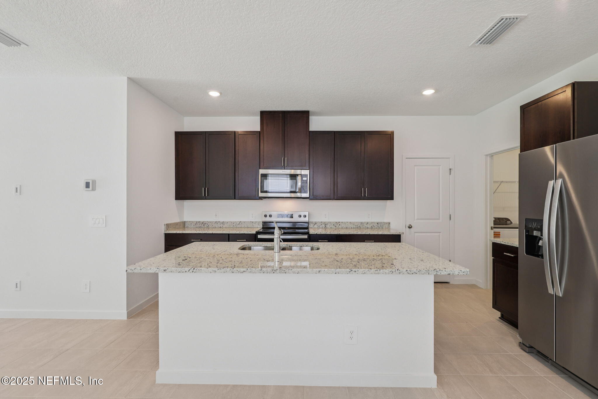7351 Queensgate Circle Jacksonville, FL 32219 - Photo 13 of 38 a kitchen with stainless steel appliances granite countertop a sink a stove a refrigerator a washer and dryer