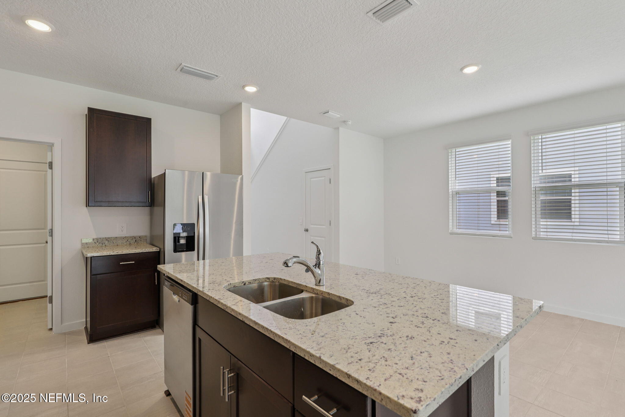 7351 Queensgate Circle Jacksonville, FL 32219 - Photo 15 of 38 a kitchen that has a sink a stove and refrigerator