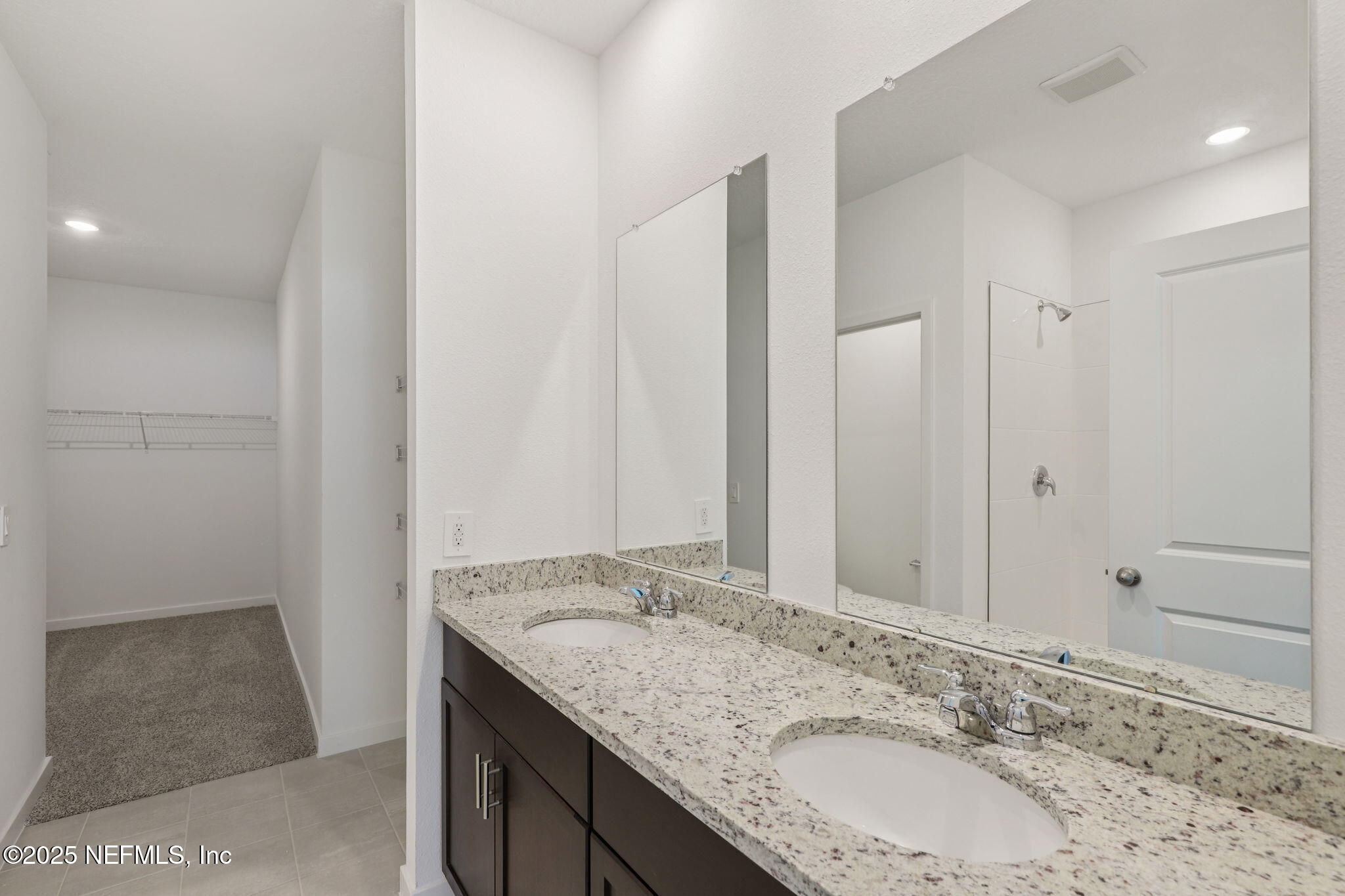 7351 Queensgate Circle Jacksonville, FL 32219 - Photo 22 of 38 a bathroom with a granite countertop sink and a mirror