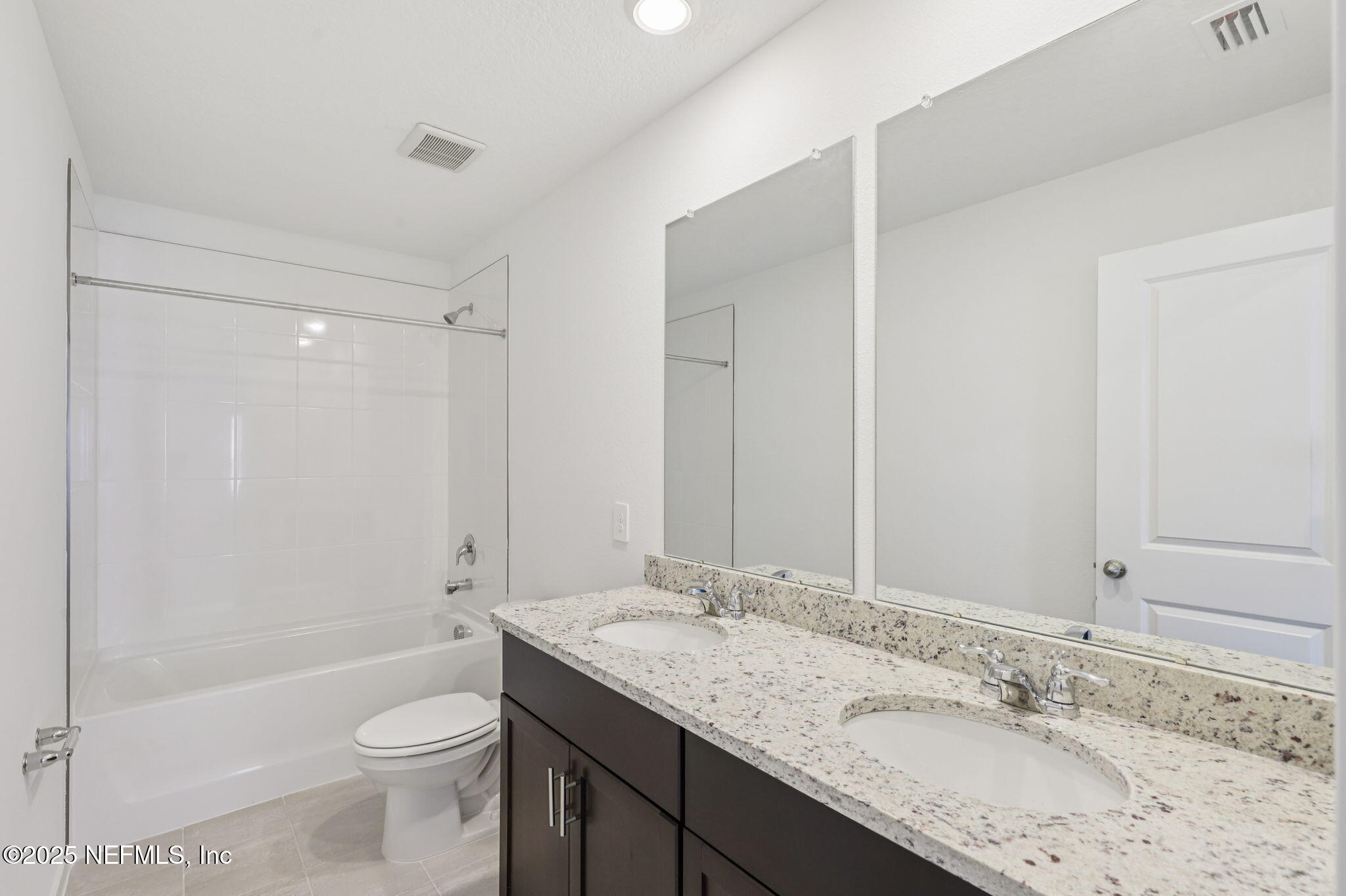 7351 Queensgate Circle Jacksonville, FL 32219 - Photo 27 of 38 a bathroom with a granite countertop sink toilet and shower