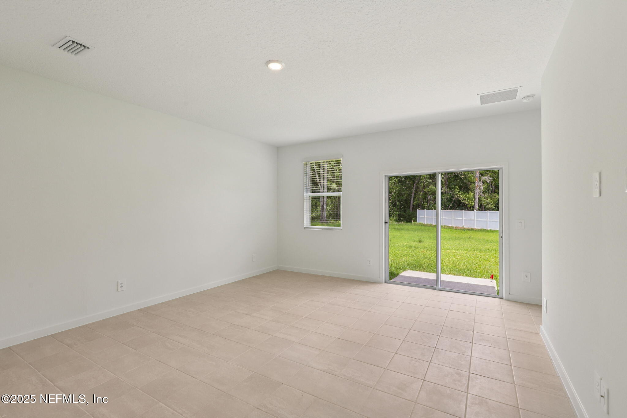 7351 Queensgate Circle Jacksonville, FL 32219 - Photo 7 of 38 a view of an empty room with glass door