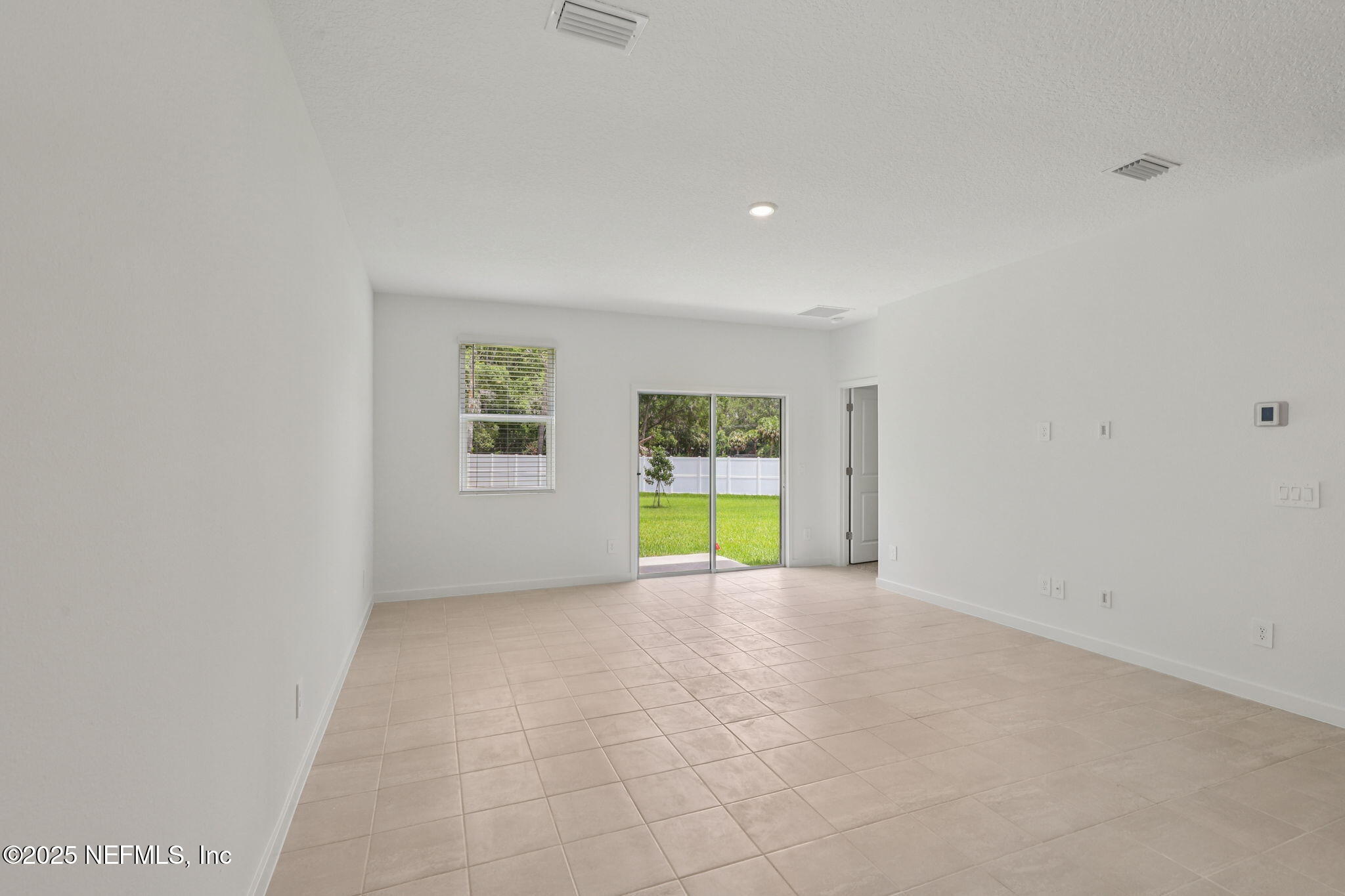 7351 Queensgate Circle Jacksonville, FL 32219 - Photo 9 of 38 a view of an empty room with a window
