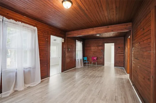 a view of empty room with wooden floor