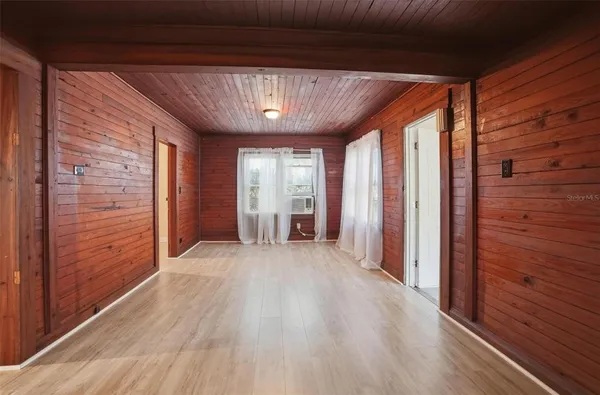 a view of hallway with wooden floor