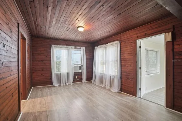 an empty room with closet and wooden floor