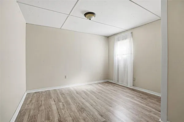 a view of room with wooden floor