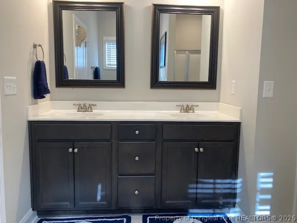 a bathroom with a double vanity sink and mirror