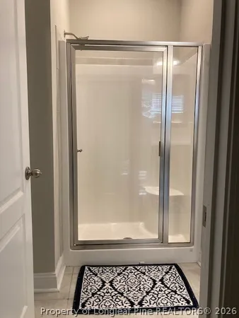 a bathroom with a glass shower door